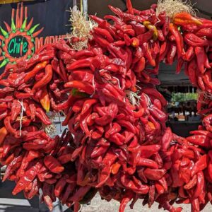 two Hatch red chile wreaths in front of Farmers Chile Market in Albuquerque, NM