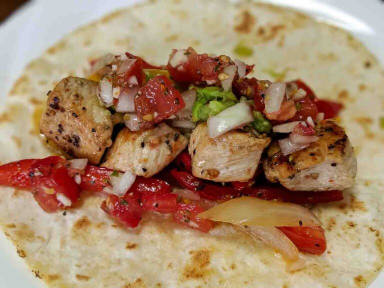 a chicken taco on a corn tortilla with salsa made with Hatch red chile powder