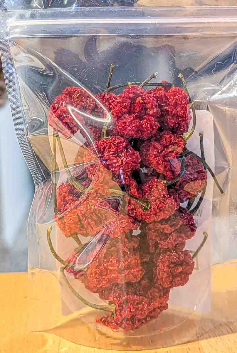 the back of a bag full of dried carolina reapers chili peppers